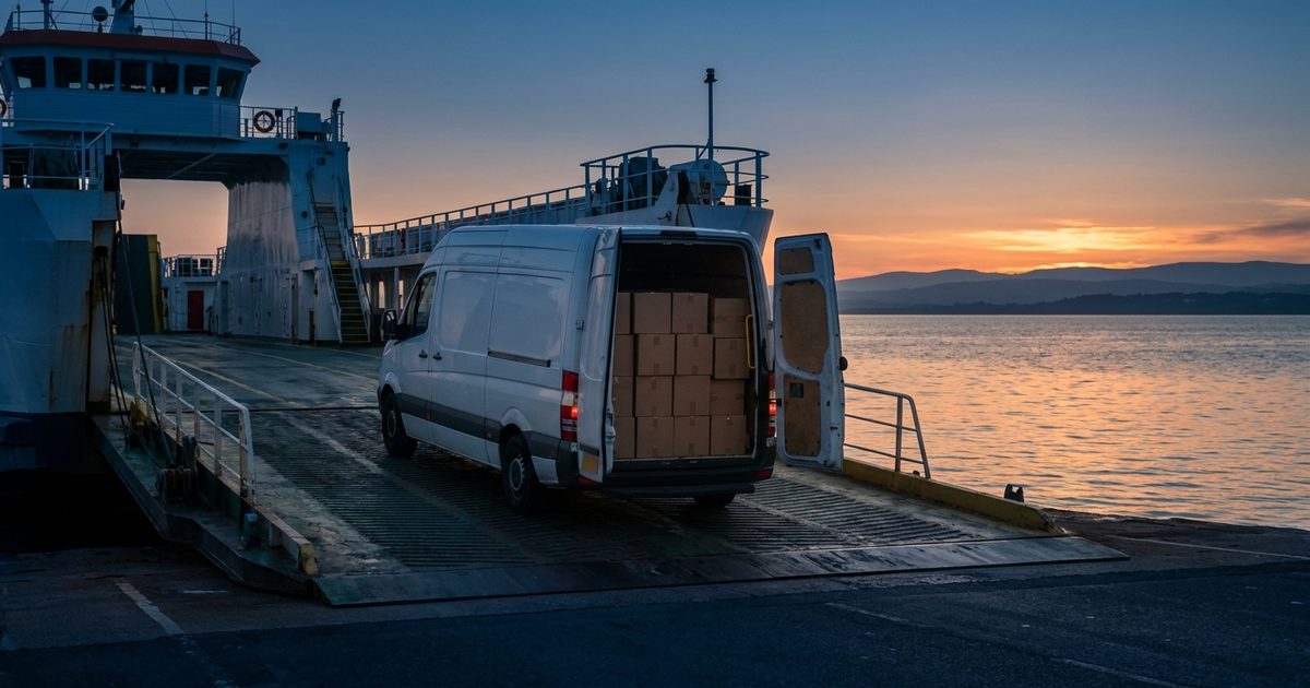 A white van loaded with plain cartons driving onto a car ferry at dusk, the sea and a distant coastline behind, illustrating parcels leaving the UK for customers in the EU.